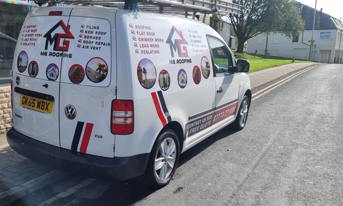 Cut vinyl van lettering on a white VW Caddy — MG Roofing trading name, service list and phone number across the rear doors and side panel